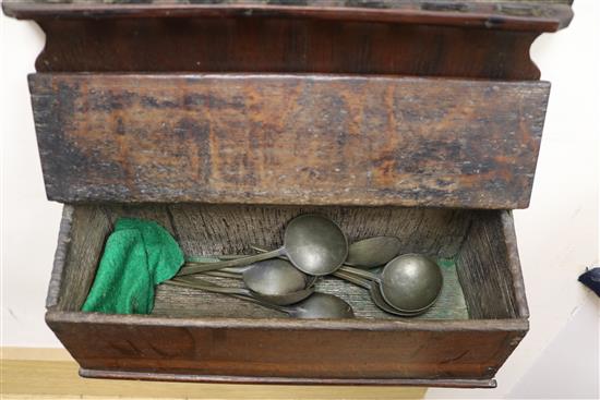 An 18th century oak candlebox and a spoon rack housing eight pewter spoons